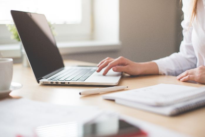 business woman working on laptop in her office picjumbo com